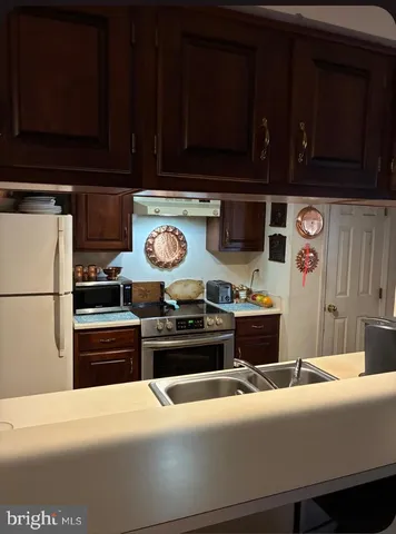 a kitchen with stainless steel appliances a stove and a refrigerator