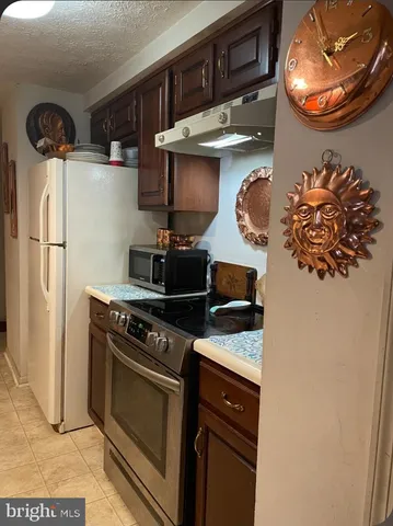a kitchen with stainless steel appliances granite countertop a stove and a refrigerator