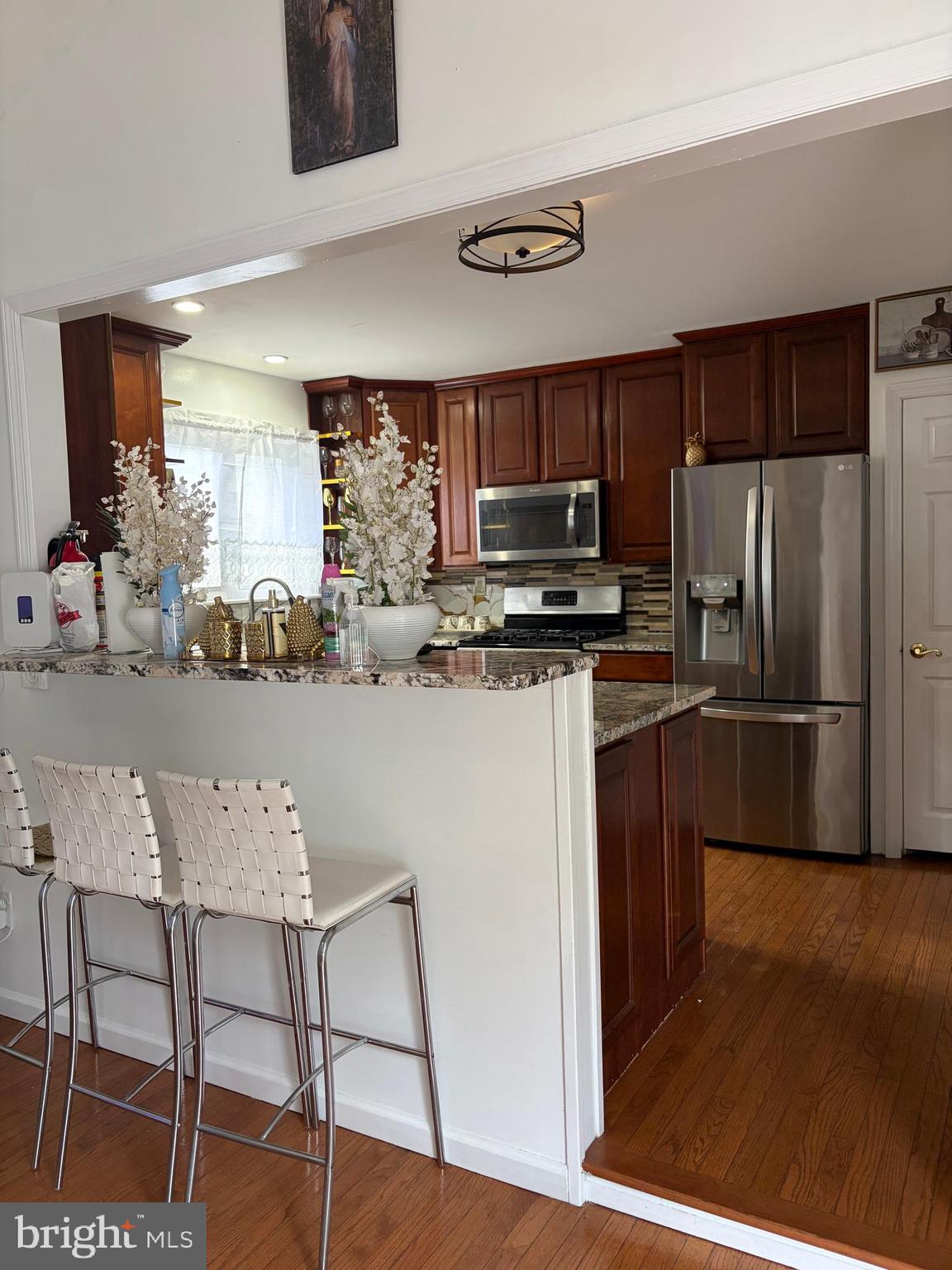7404 Wyndam Road Pennsauken, NJ 08110 - Photo 11 of 50 a kitchen with kitchen island a refrigerator stove and microwave