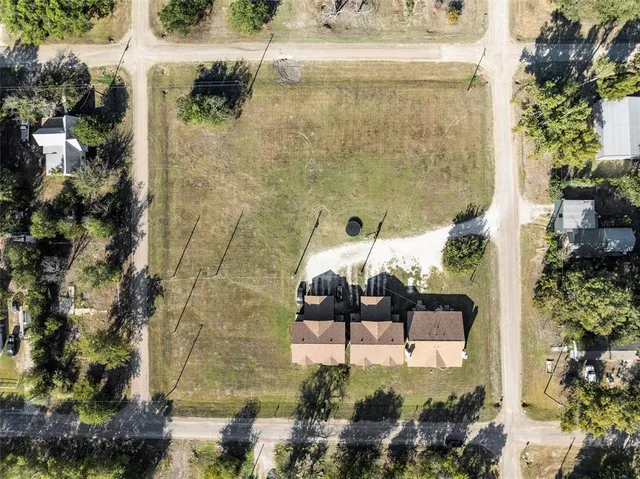 a balcony with a table and chairs and potted plants