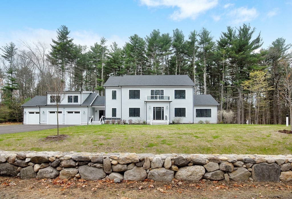 62 Pope Road Acton, MA 01720 - Photo 1 of 39 a front view of a house with a garden and swimming pool
