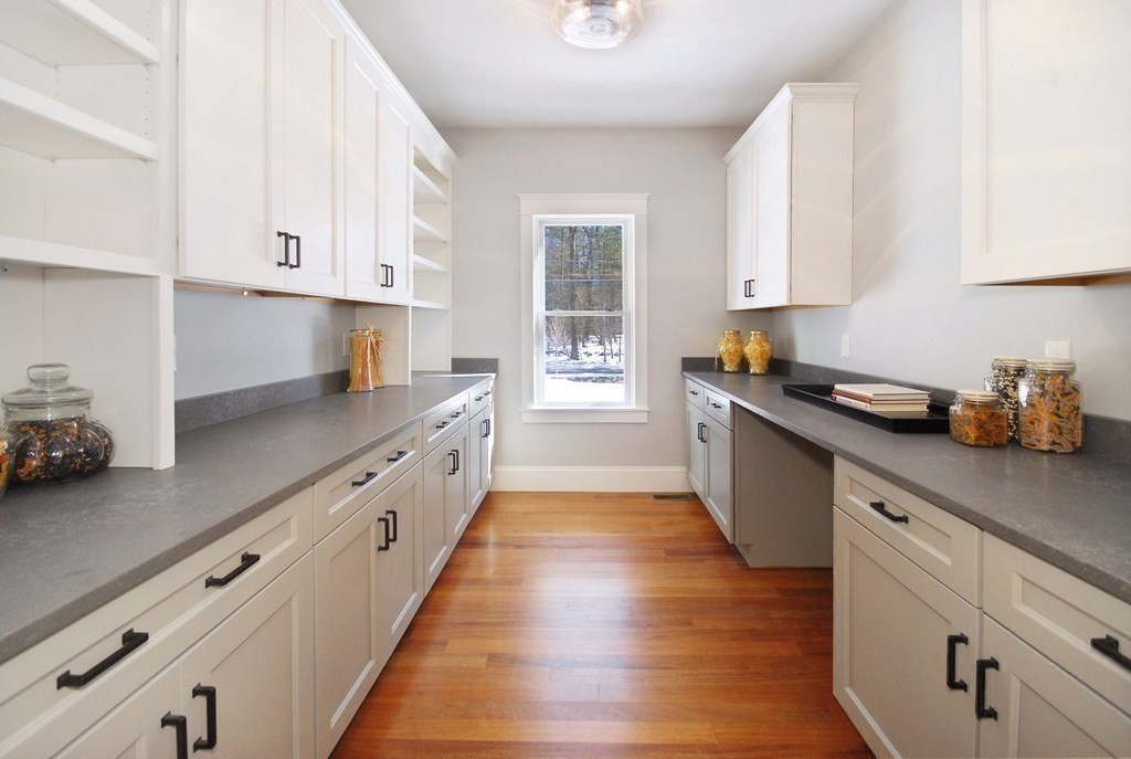 62 Pope Road Acton, MA 01720 - Photo 12 of 39 a kitchen with granite countertop white cabinets and wooden floor