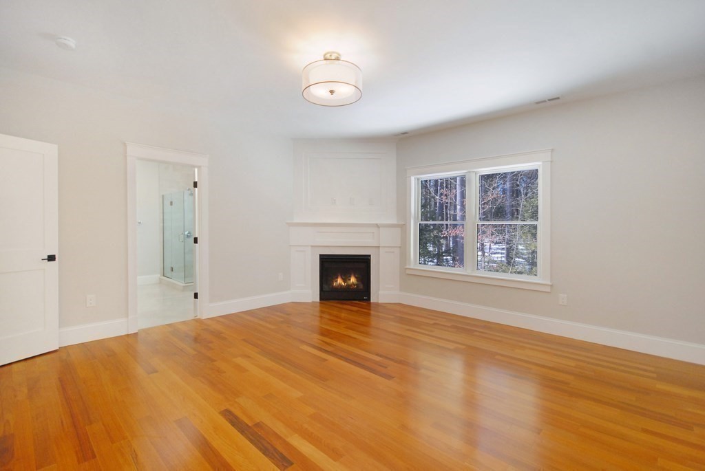 62 Pope Road Acton, MA 01720 - Photo 25 of 39 a view of an empty room with a window and fireplace