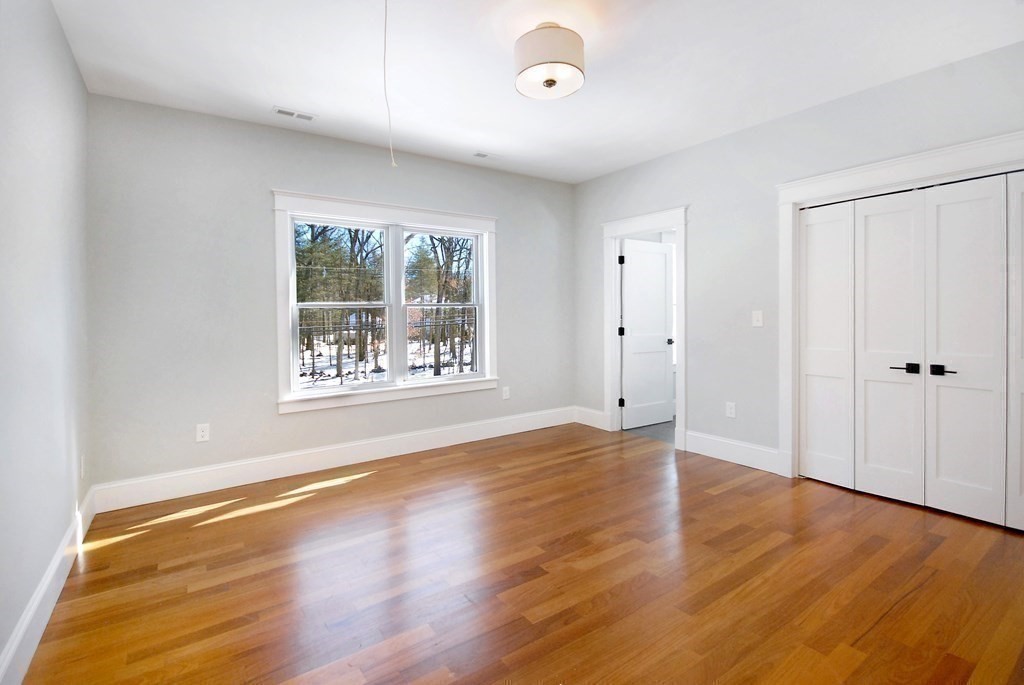 62 Pope Road Acton, MA 01720 - Photo 28 of 39 an empty room with wooden floor and windows