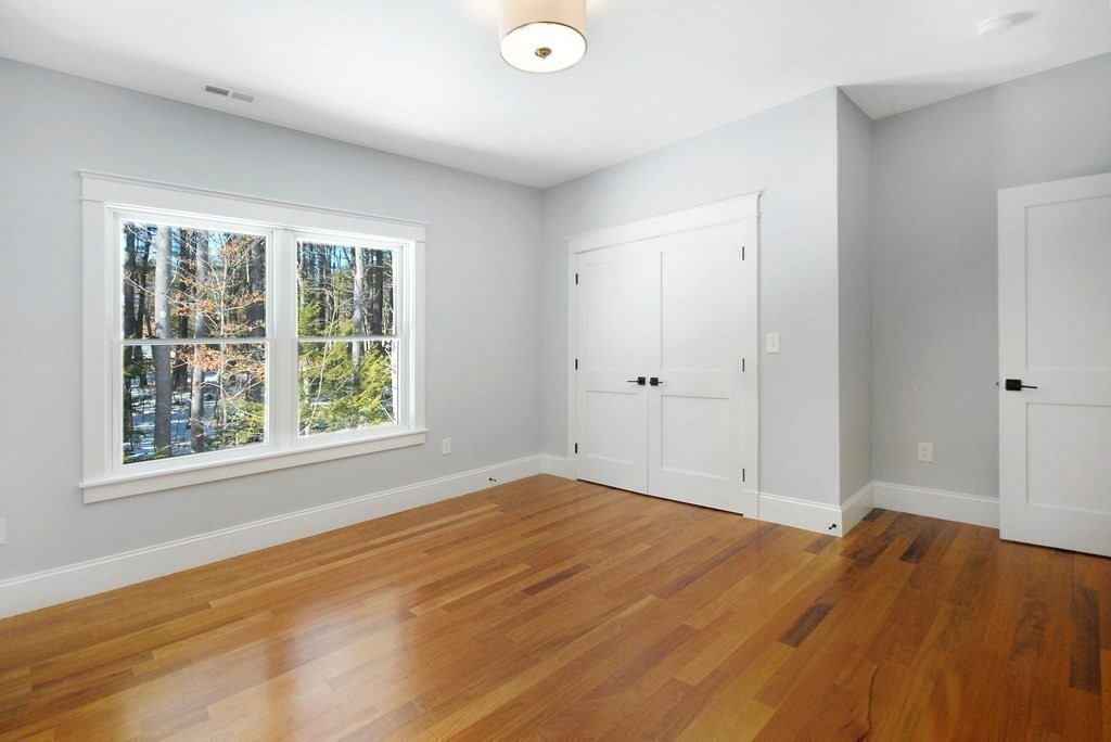 62 Pope Road Acton, MA 01720 - Photo 30 of 39 a view of empty room with wooden floor and fan