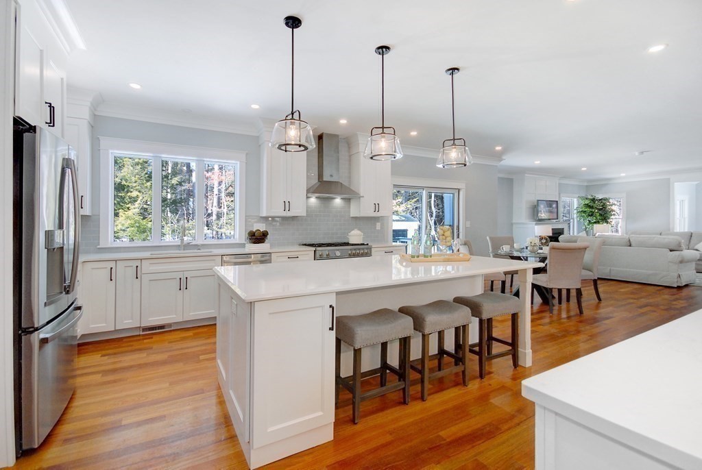 62 Pope Road Acton, MA 01720 - Photo 9 of 39 a large kitchen with kitchen island a large island in it