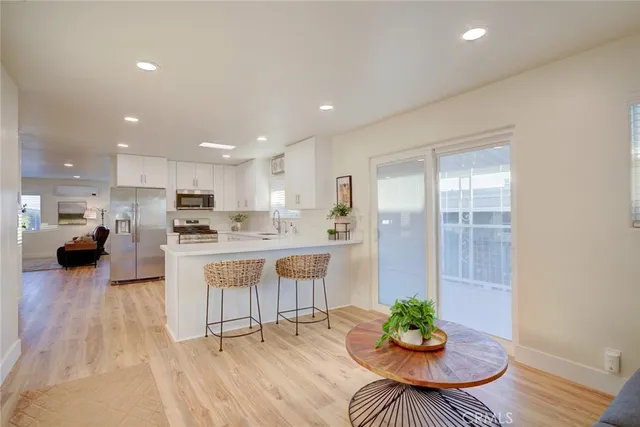 a living room with kitchen island furniture and a potted plant