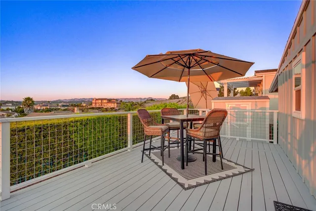 a view of a roof deck with table and chairs