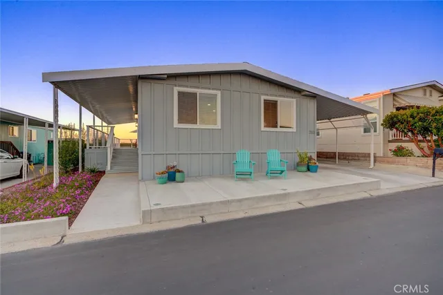a backyard of a house with table and chairs