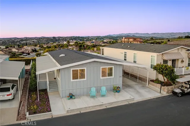 an aerial view of a house with a garden and lake view