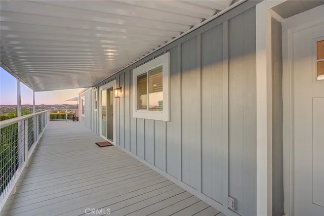 a view of a porch with wooden floor and fence