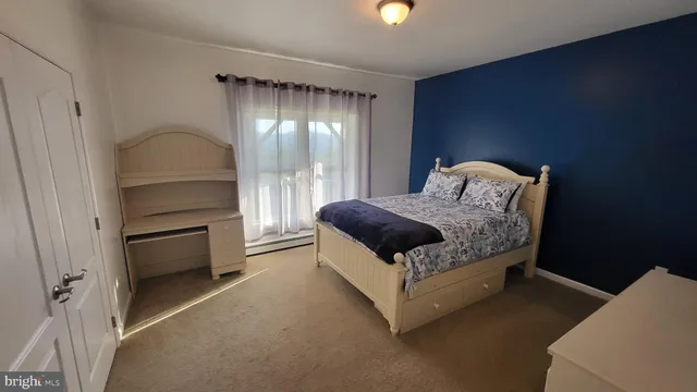 a bedroom with a bed and a dresser