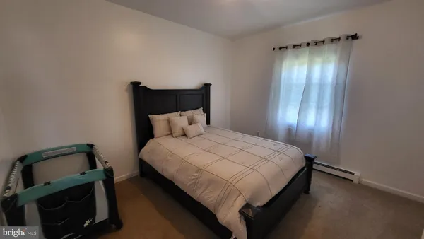 a bedroom with a bed and a mirror