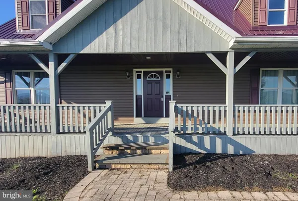 a front view of a house with entryway and stairs
