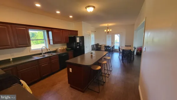 a kitchen with a table chairs sink and cabinets