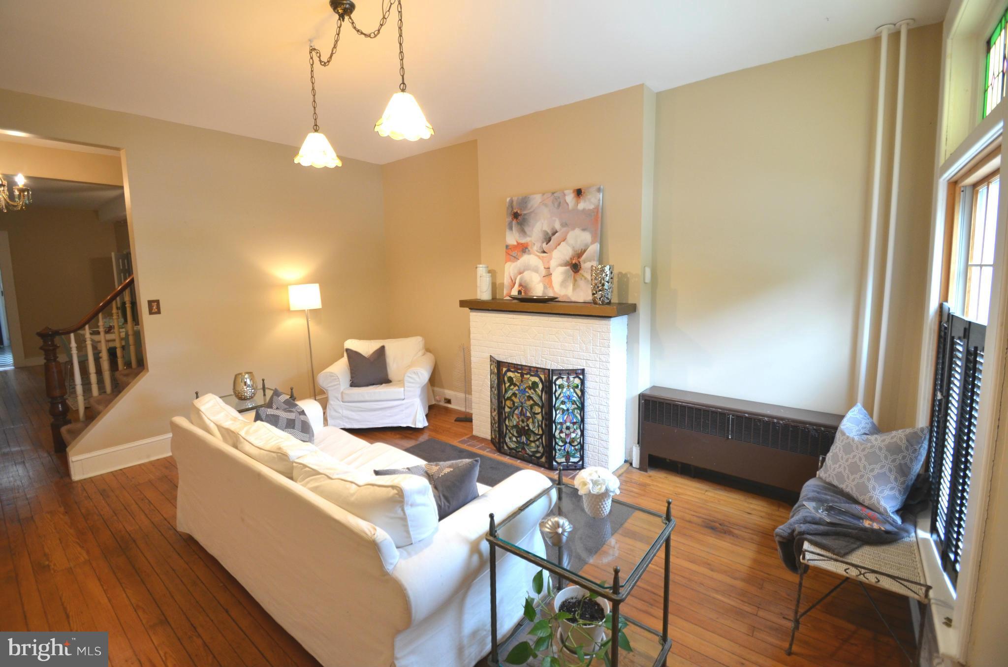 2309 Eastern Avenue Baltimore, MD 21224 - Photo 2 of 30 a living room with furniture a fireplace and a flat screen tv