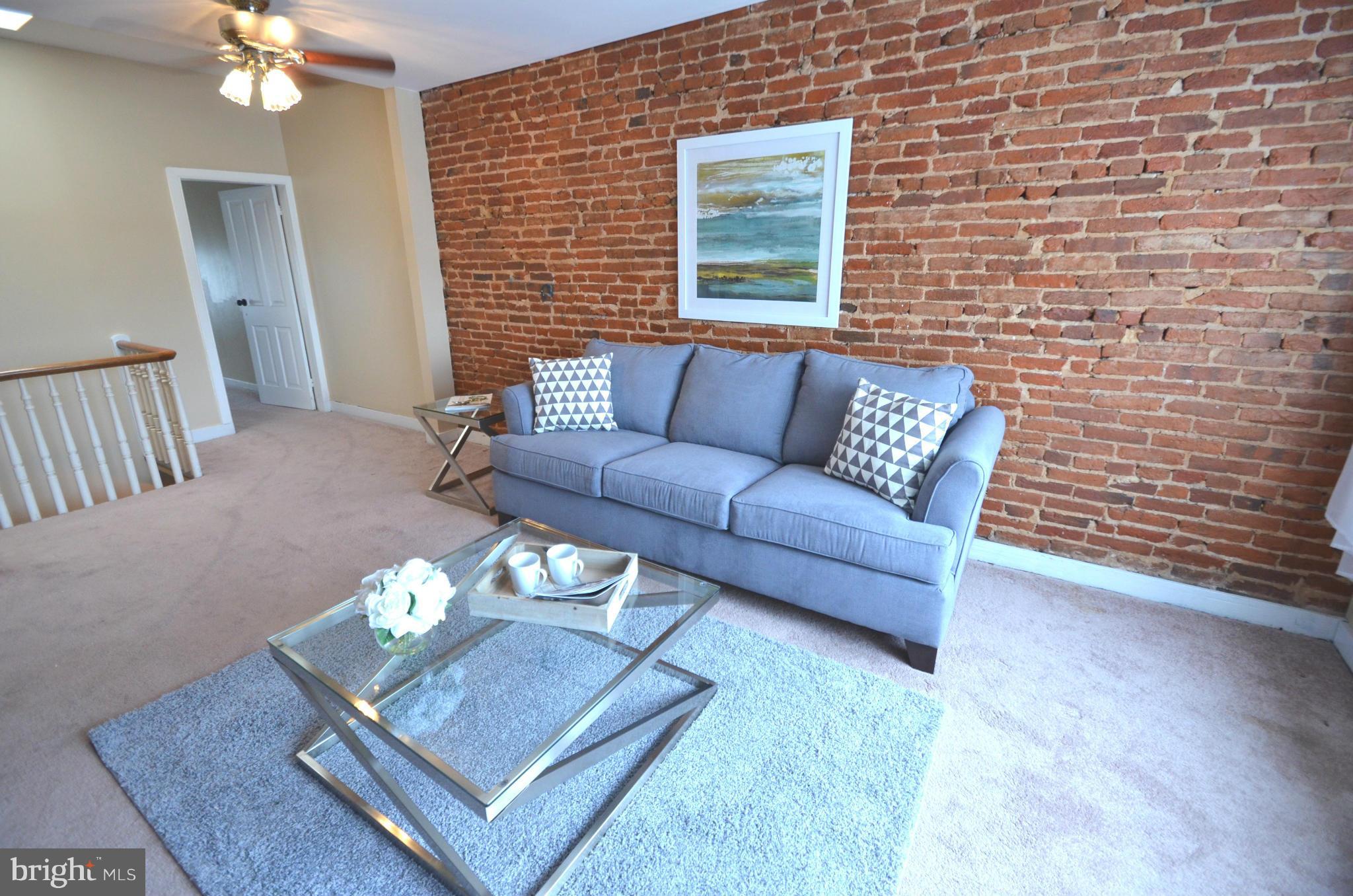 2309 Eastern Avenue Baltimore, MD 21224 - Photo 11 of 30 a living room with furniture and a dining table