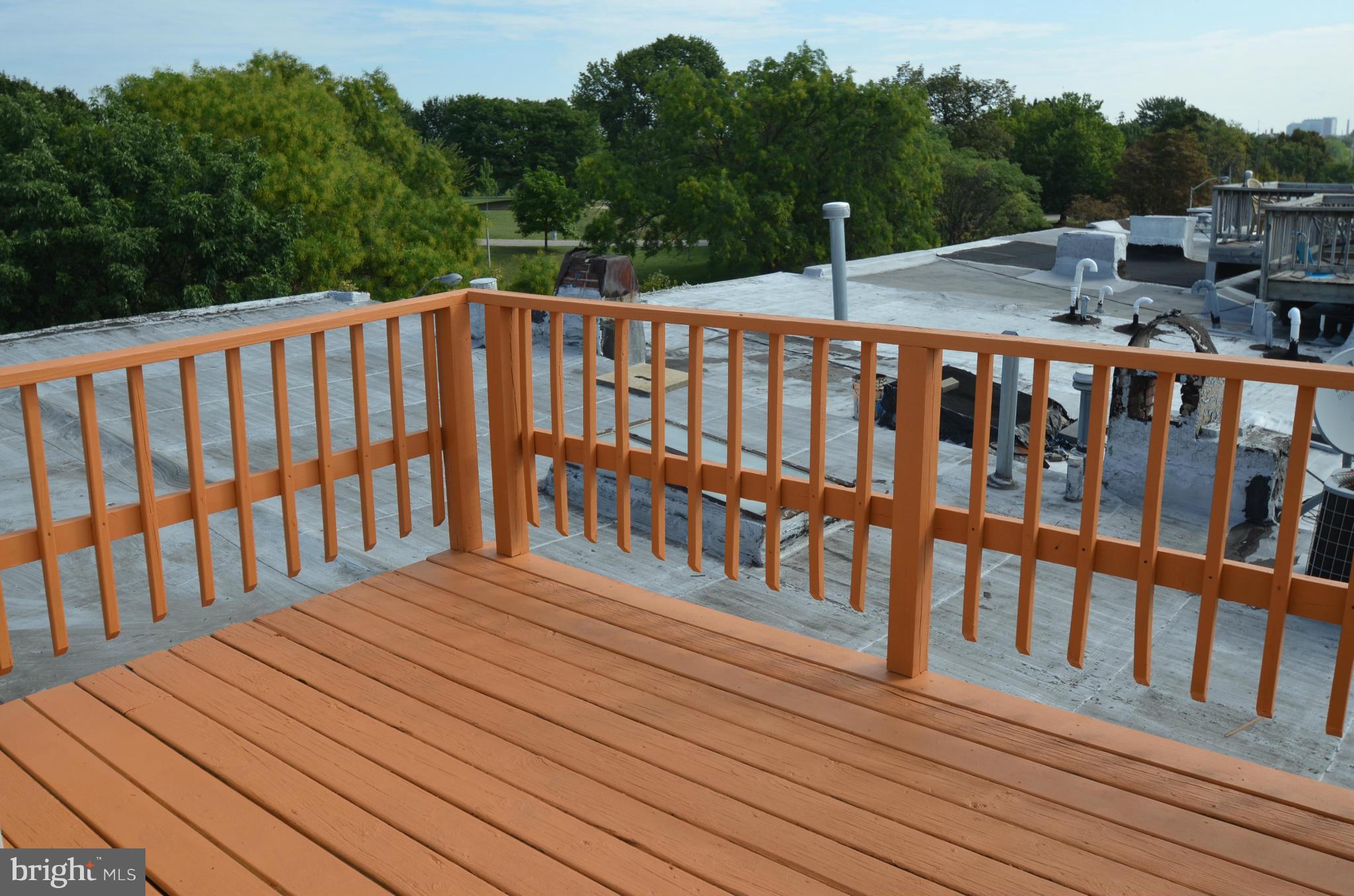 2309 Eastern Avenue Baltimore, MD 21224 - Photo 15 of 30 a balcony view with wooden floor and trees in the background