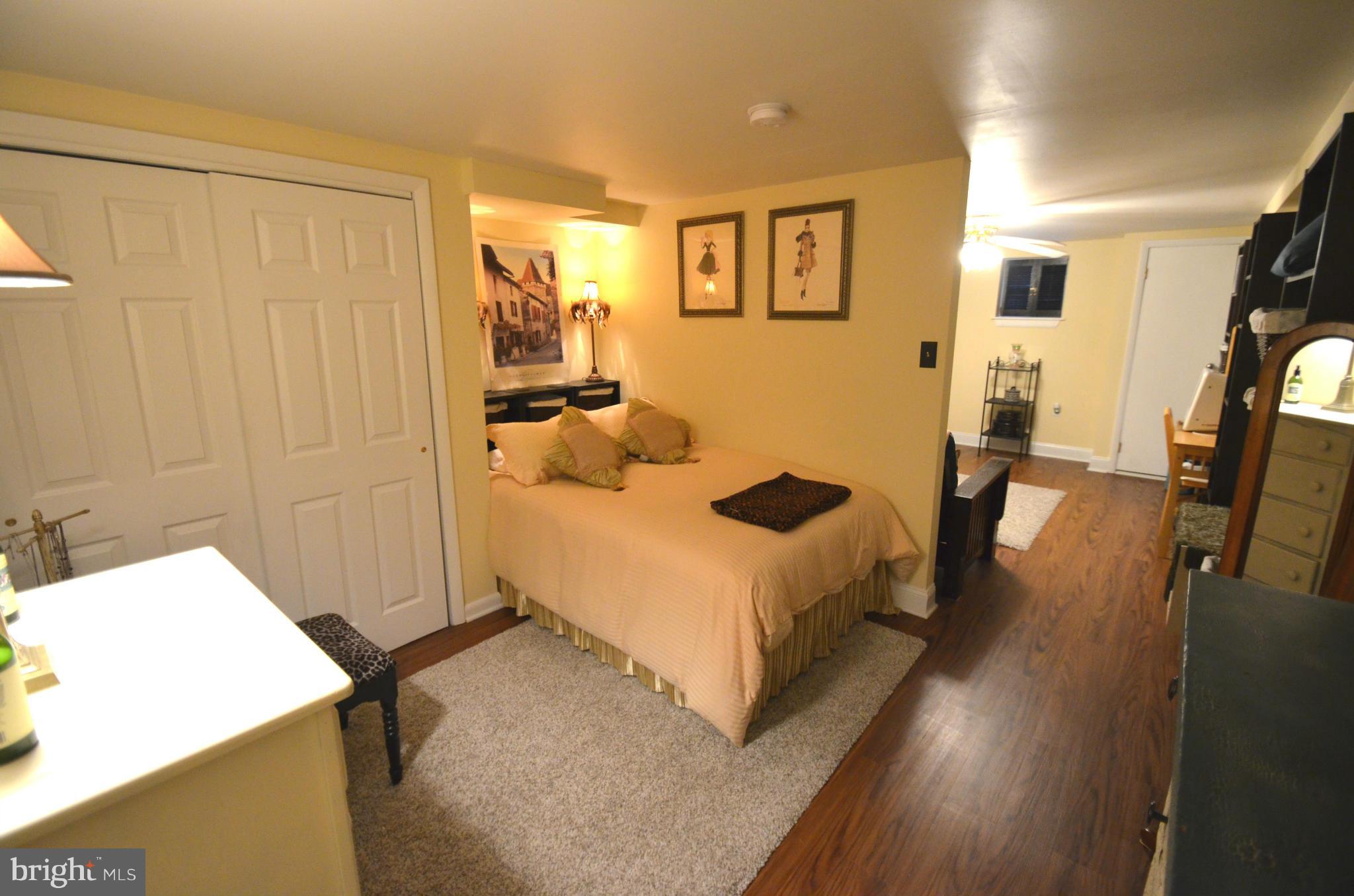 2309 Eastern Avenue Baltimore, MD 21224 - Photo 22 of 30 a spacious bedroom with a bed and wooden floor