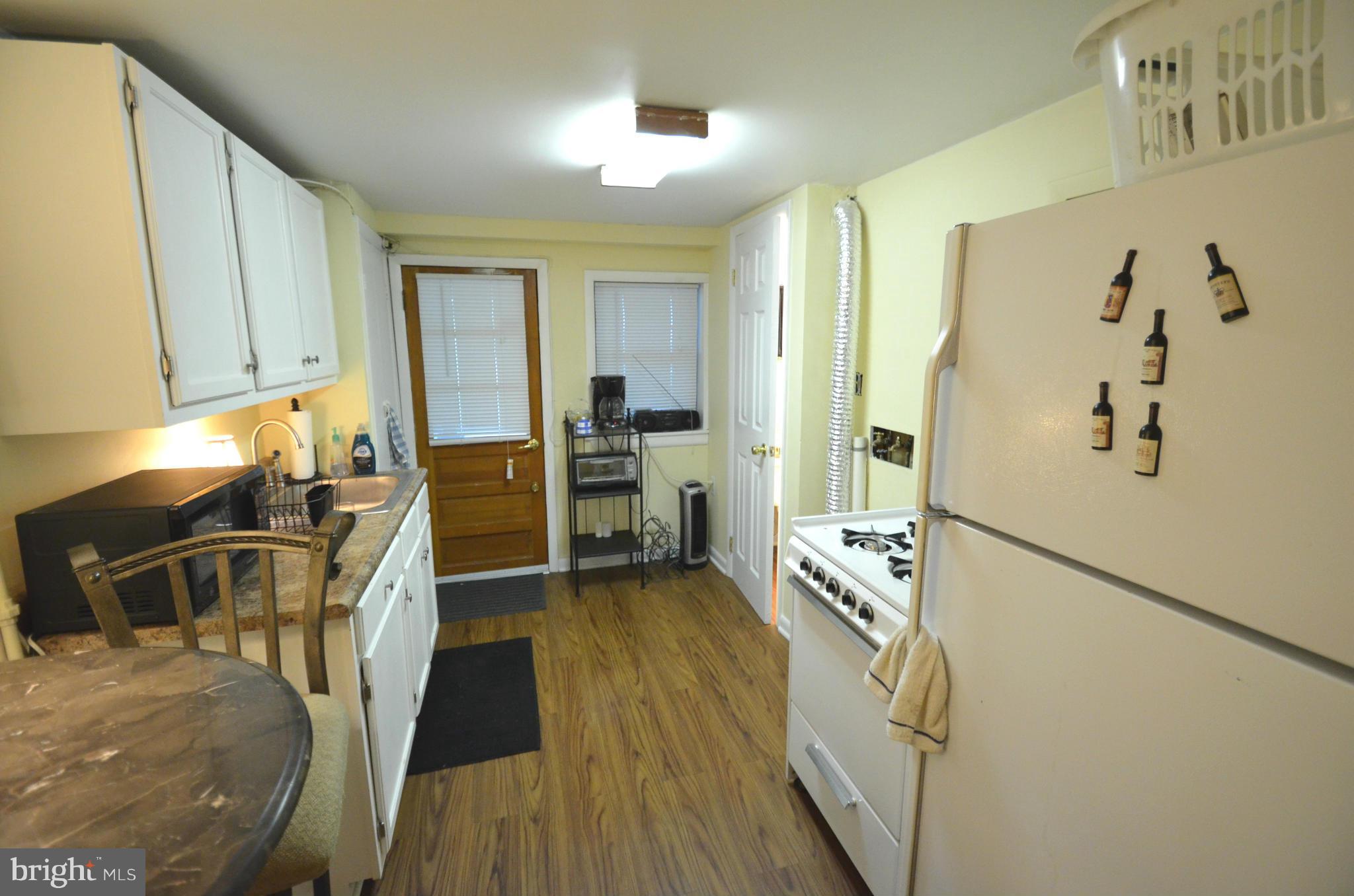 2309 Eastern Avenue Baltimore, MD 21224 - Photo 25 of 30 a view of a kitchen with fridge and wooden floor