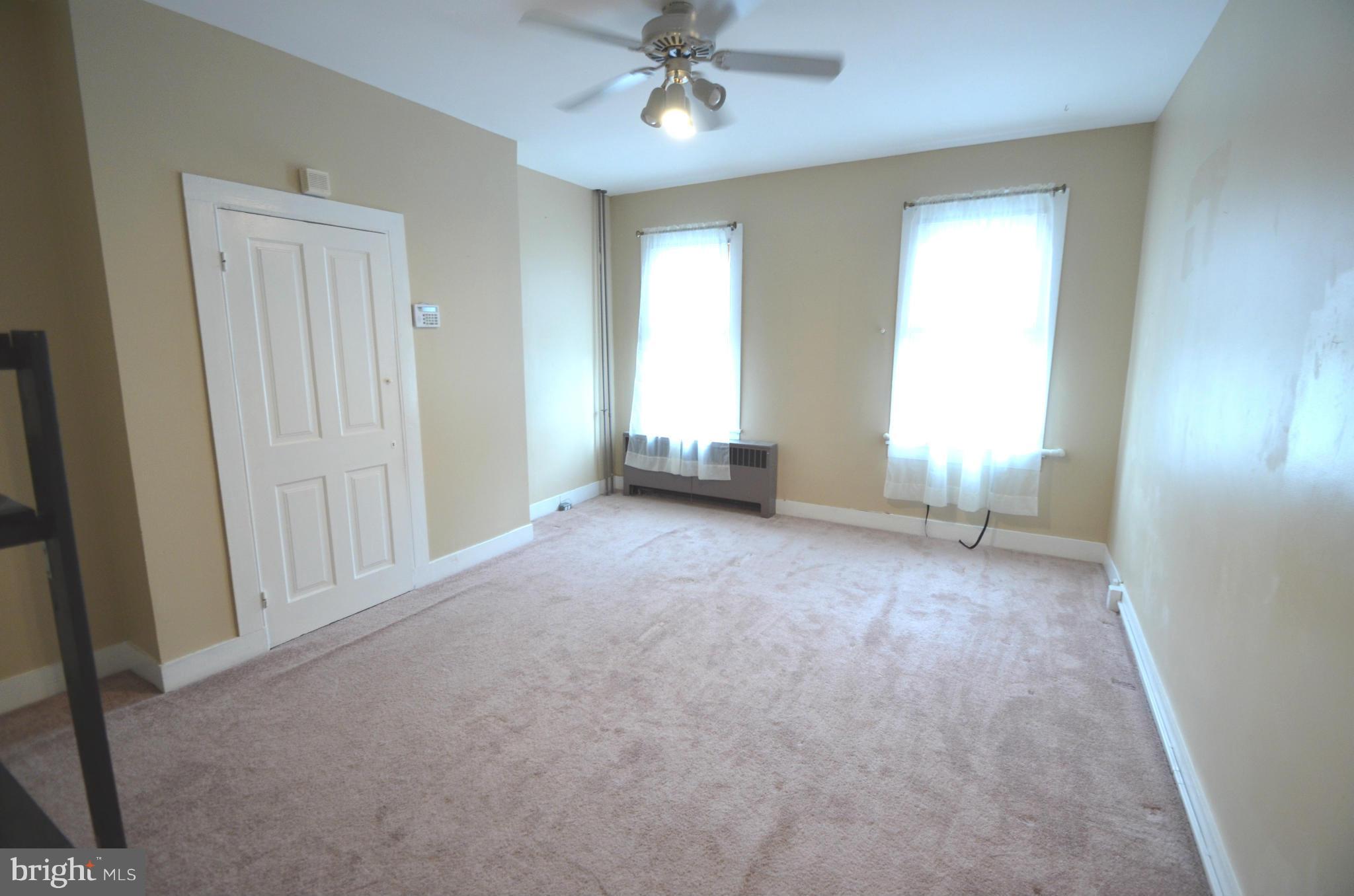 2309 Eastern Avenue Baltimore, MD 21224 - Photo 10 of 30 an empty room with windows and fan