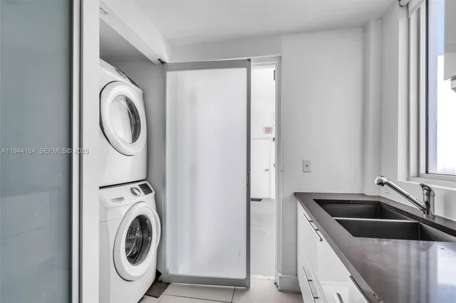 a utility room with sink dryer and washer