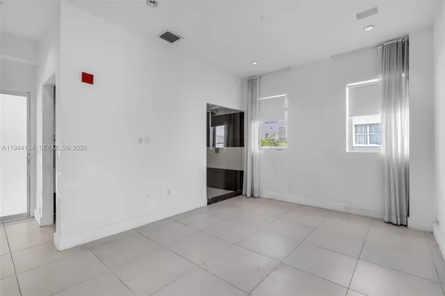 an empty room with windows and closet