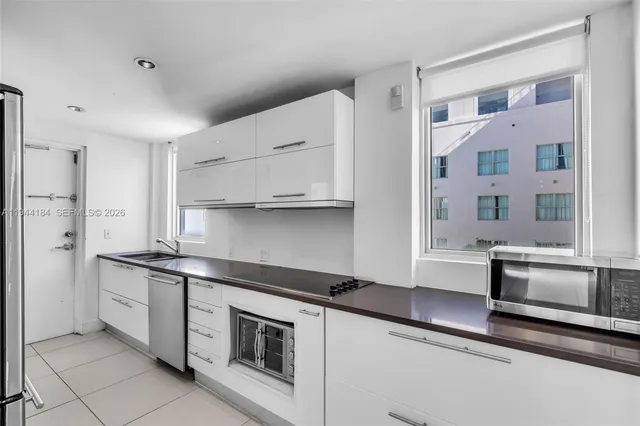 a kitchen with stainless steel appliances a sink and a stove