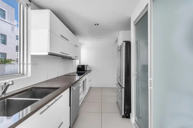 a kitchen with a sink and a refrigerator
