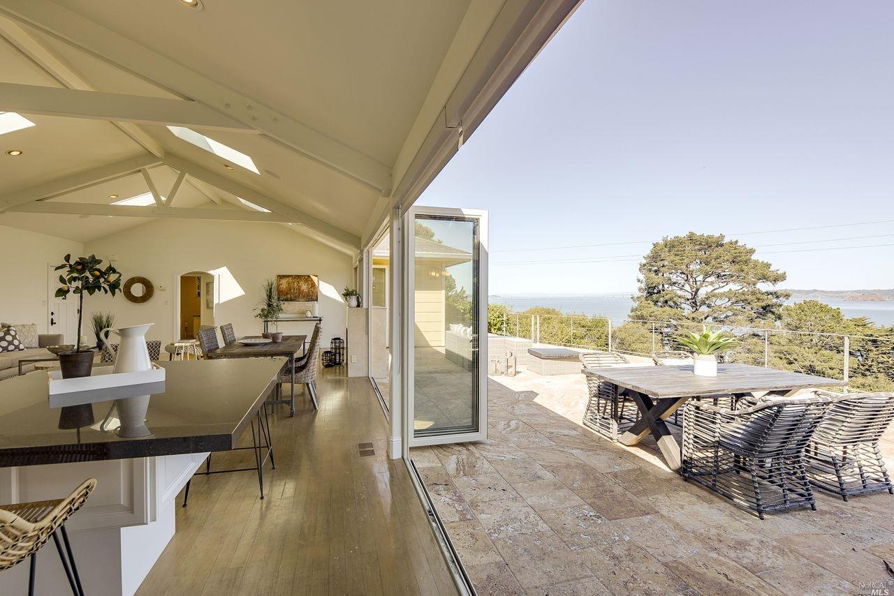 a dining room with furniture and a floor to ceiling window