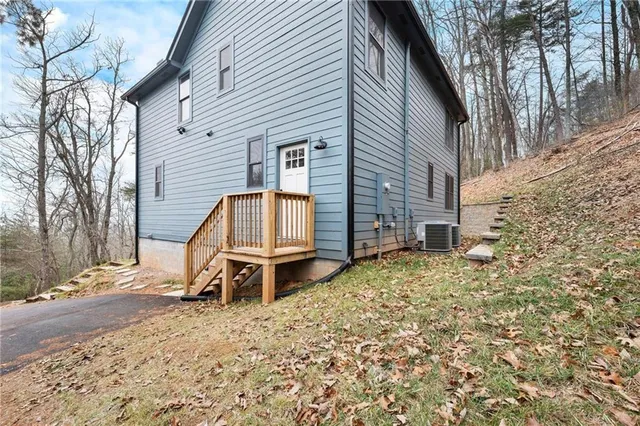 a backyard of a house with table and chairs