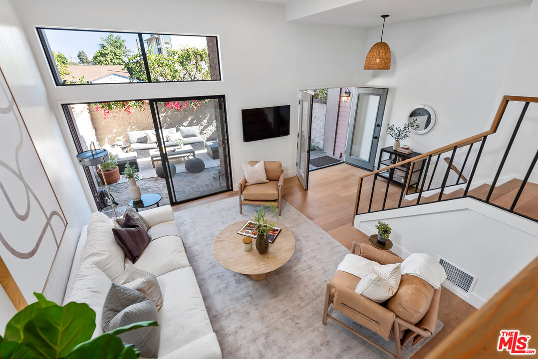 a living room with furniture and a floor to ceiling window