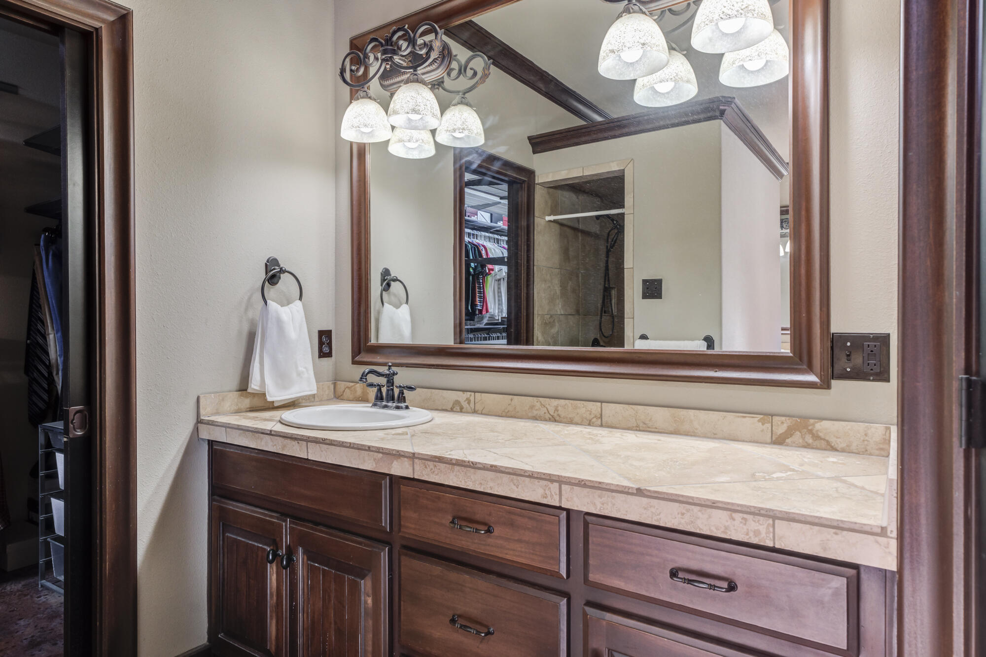 41 South Lake Shore Drive Ransom Canyon, TX 79366 - Photo 39 of 56 a bathroom with a sink and a large mirror with vanity