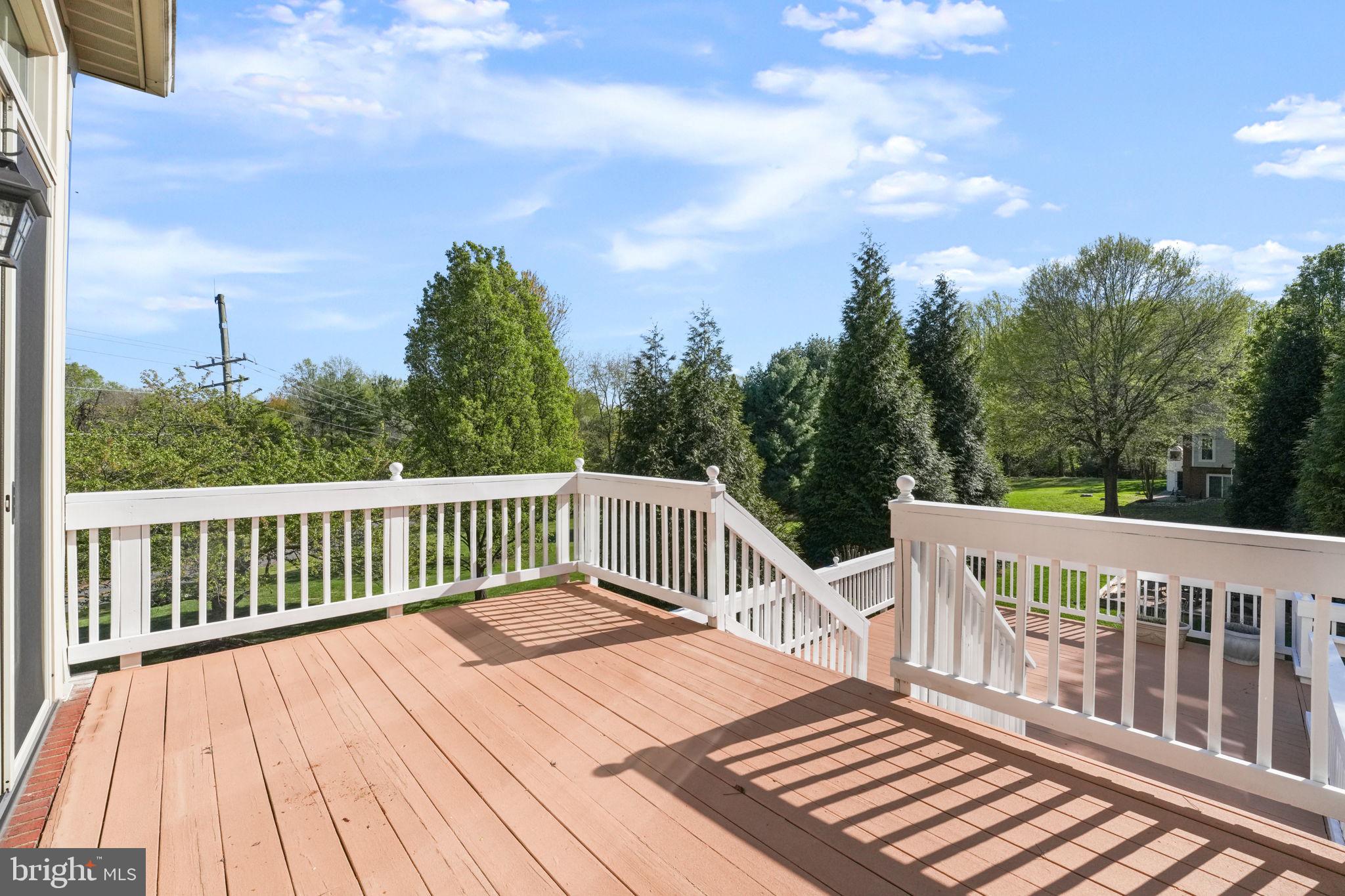 11431 Woolington Road Great Falls, VA 22066 - Photo 10 of 49 a view of a wooden deck and trees in the background