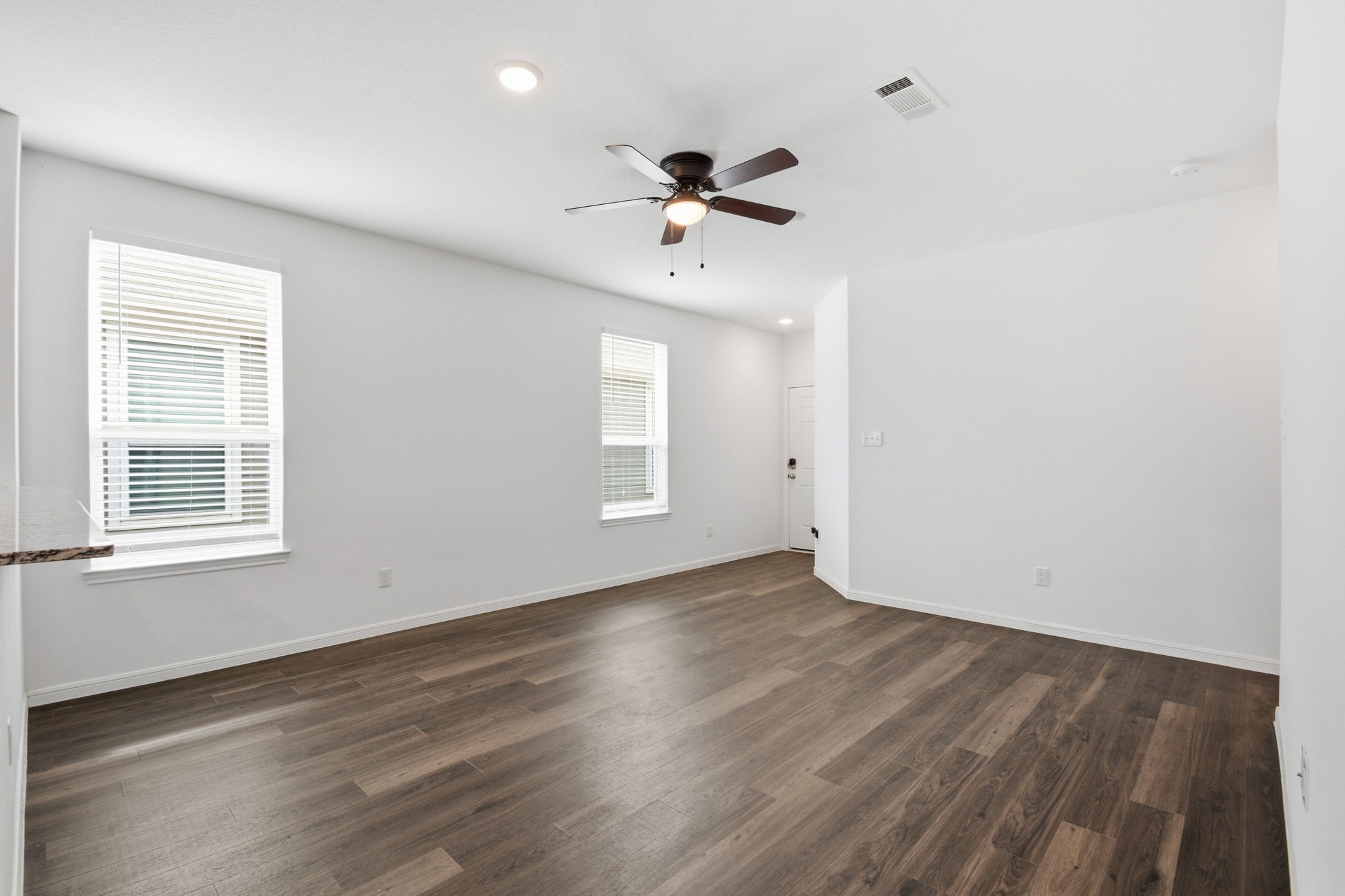 24721 Cherry Log Lane Porter, TX 77365 - Photo 11 of 36 an empty room with wooden floor ceiling fan and windows