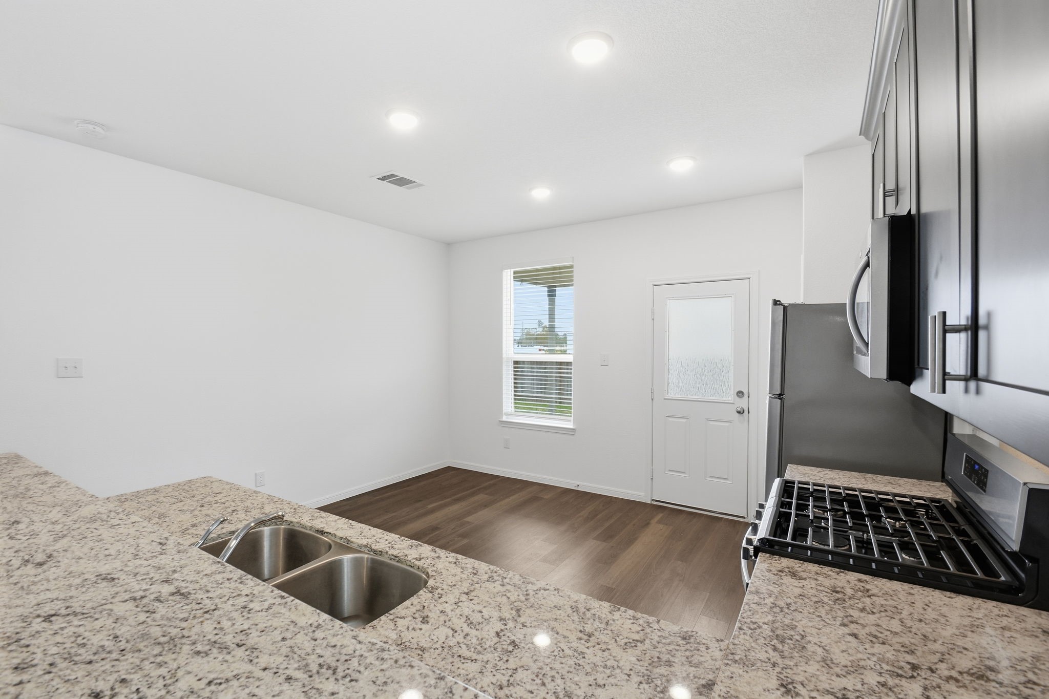 24721 Cherry Log Lane Porter, TX 77365 - Photo 16 of 36 a view of kitchen with sink refrigerator and microwave
