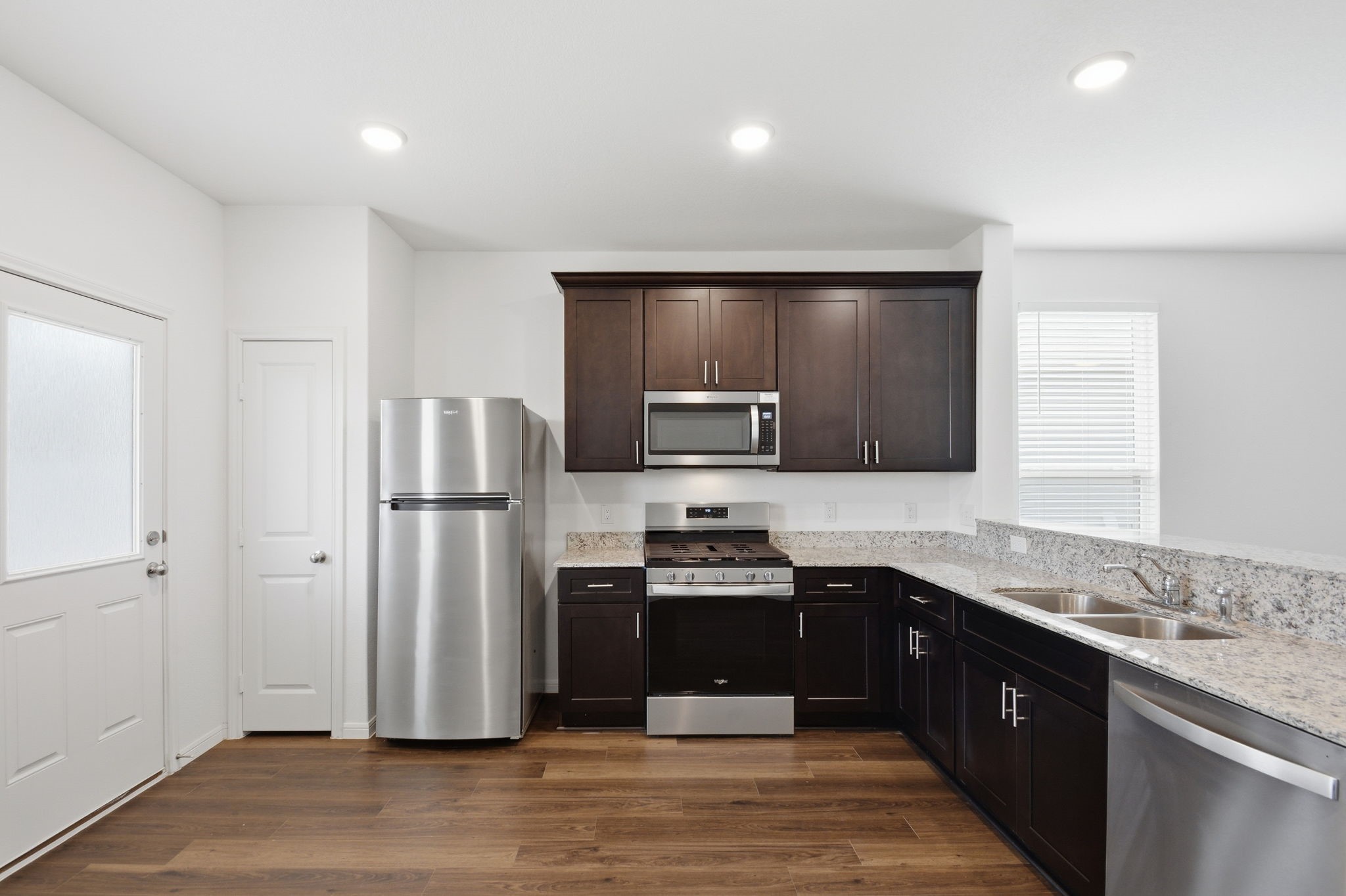 24721 Cherry Log Lane Porter, TX 77365 - Photo 18 of 36 a kitchen with stainless steel appliances granite countertop a refrigerator and a sink