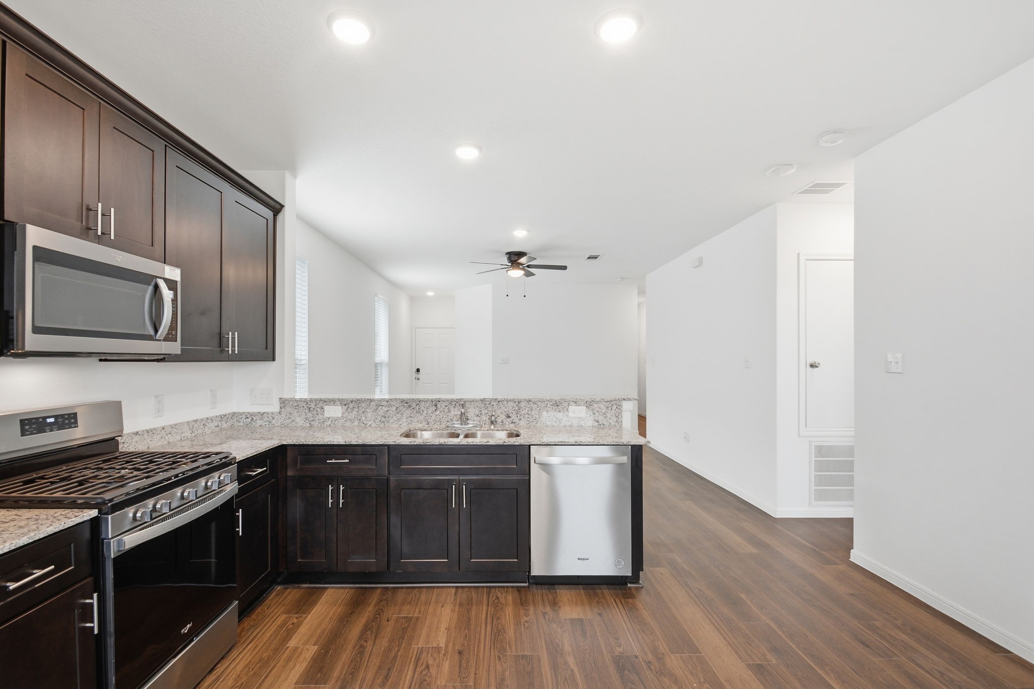 24721 Cherry Log Lane Porter, TX 77365 - Photo 19 of 36 a kitchen with stainless steel appliances granite countertop wooden cabinets and a stove top oven
