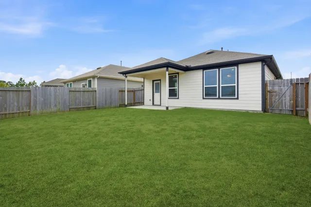 a front view of a house with a garden and yard