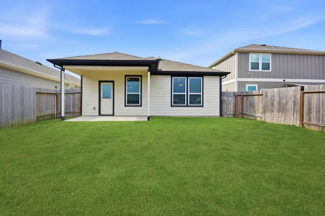 a front view of a house with a garden and yard