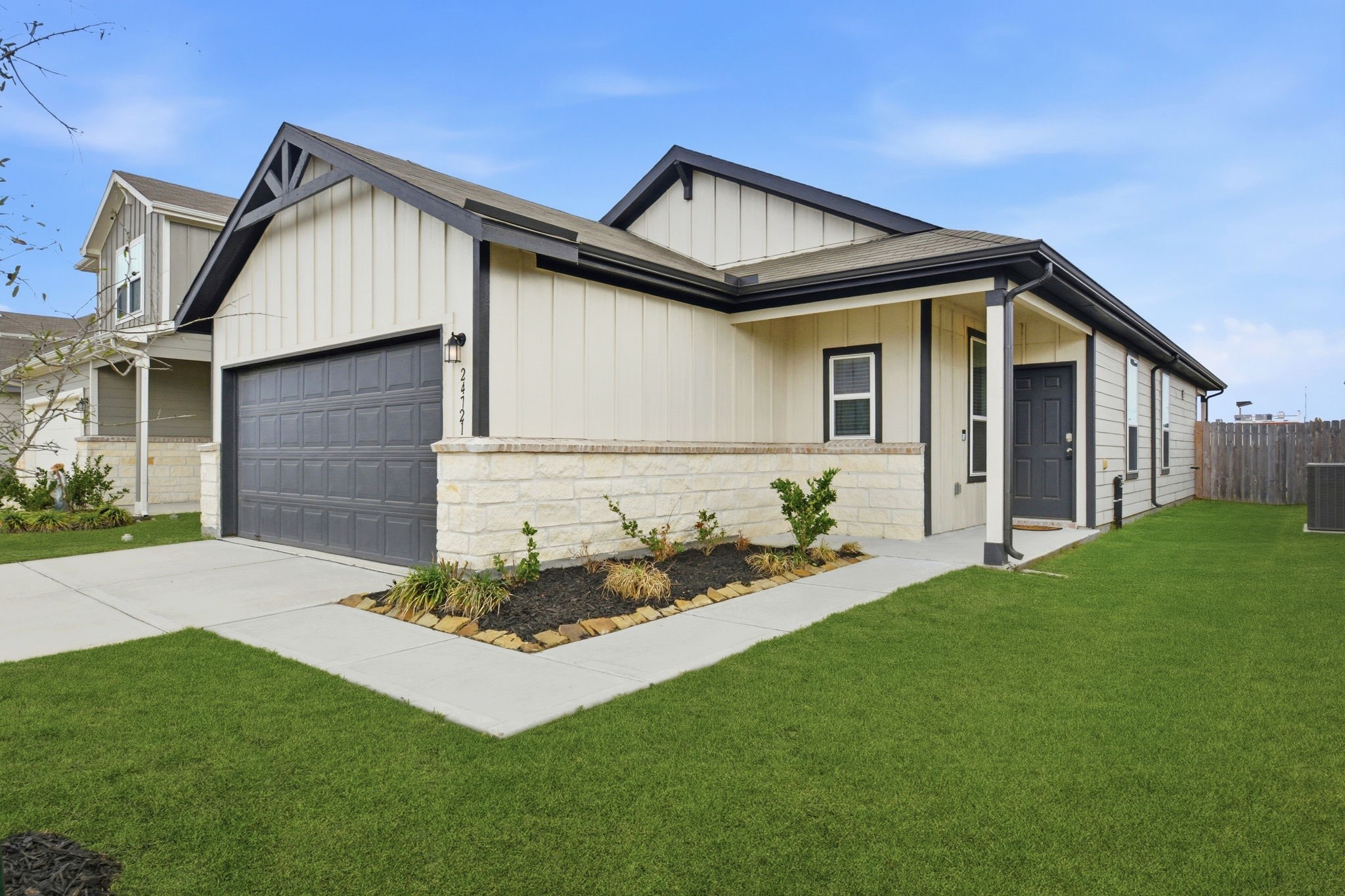 24721 Cherry Log Lane Porter, TX 77365 - Photo 4 of 36 a front view of a house with a garden