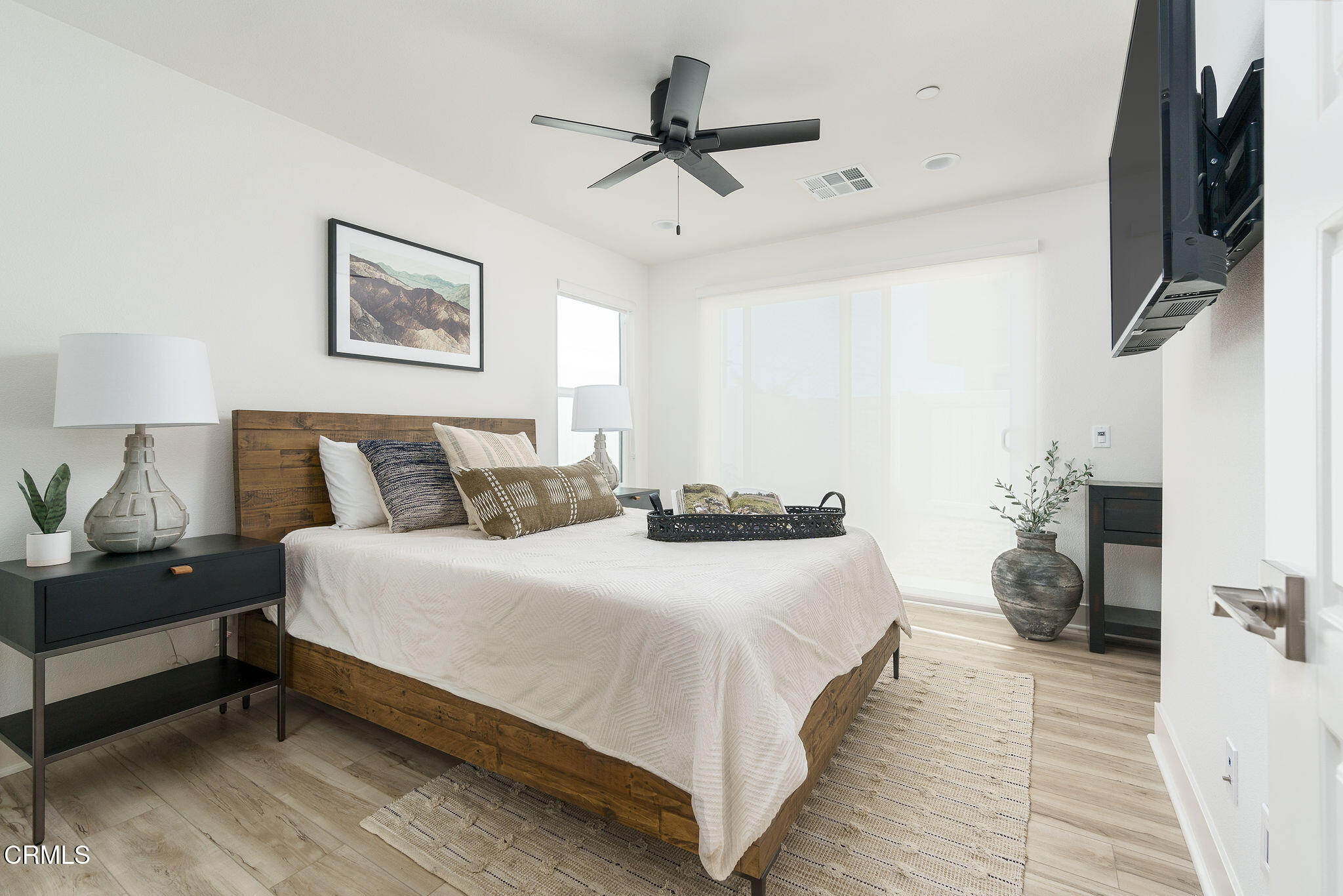 1066 Canal Street Oxnard, CA 93035 - Photo 13 of 34 a bedroom with bed and a chandelier