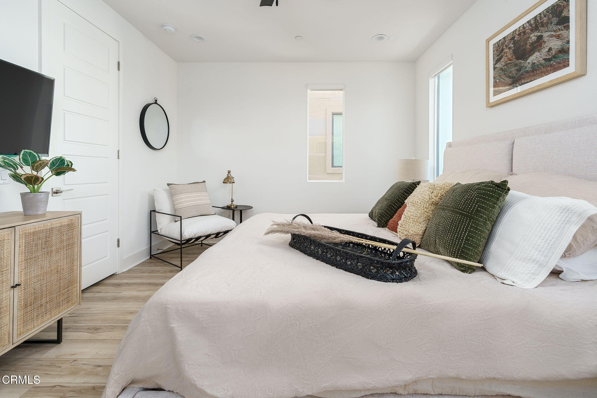 1066 Canal Street Oxnard, CA 93035 - Photo 17 of 34 a bedroom with a bed and a potted plant on the dresser