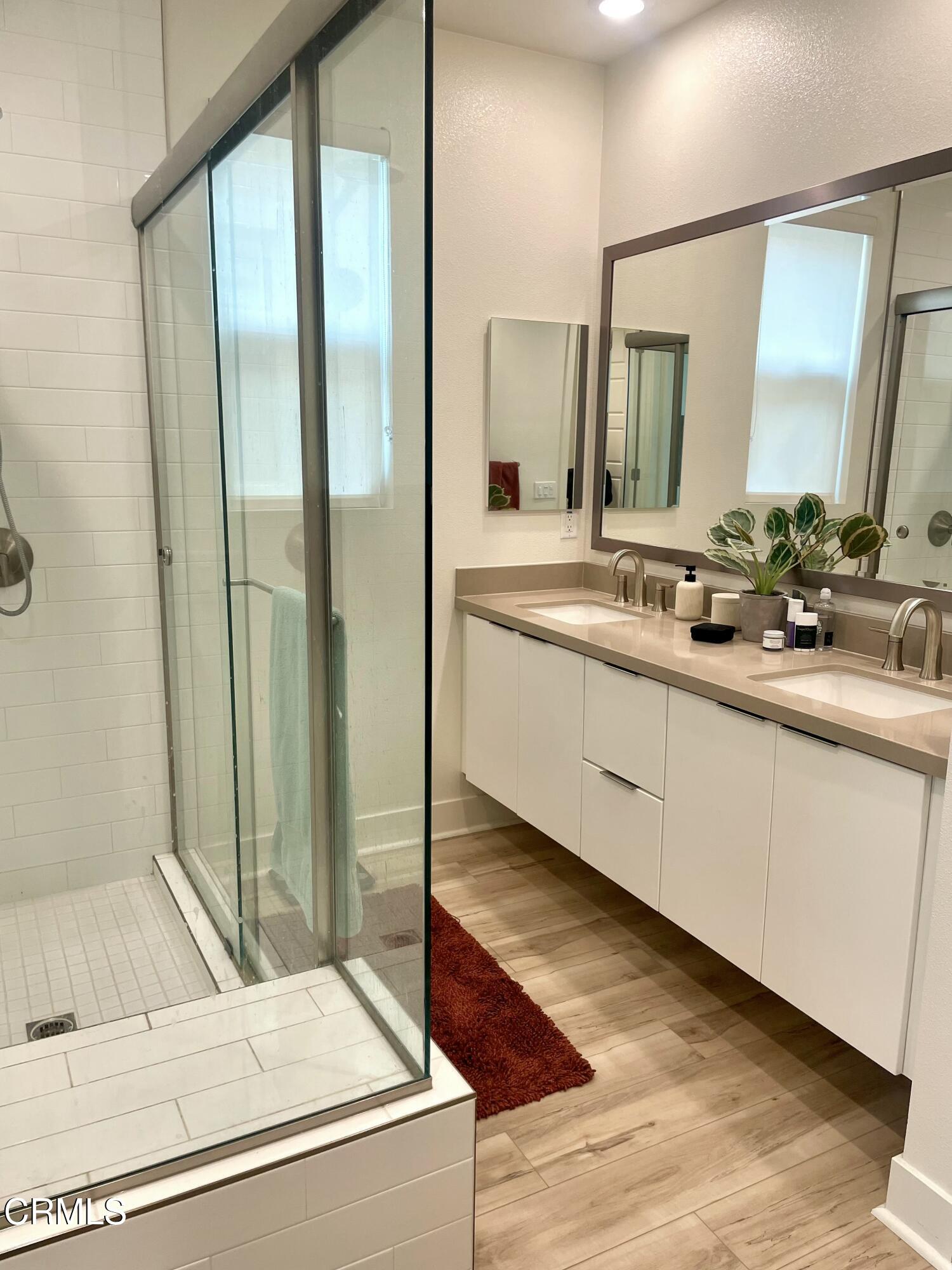 1066 Canal Street Oxnard, CA 93035 - Photo 26 of 34 a bathroom with a double vanity sink and mirror