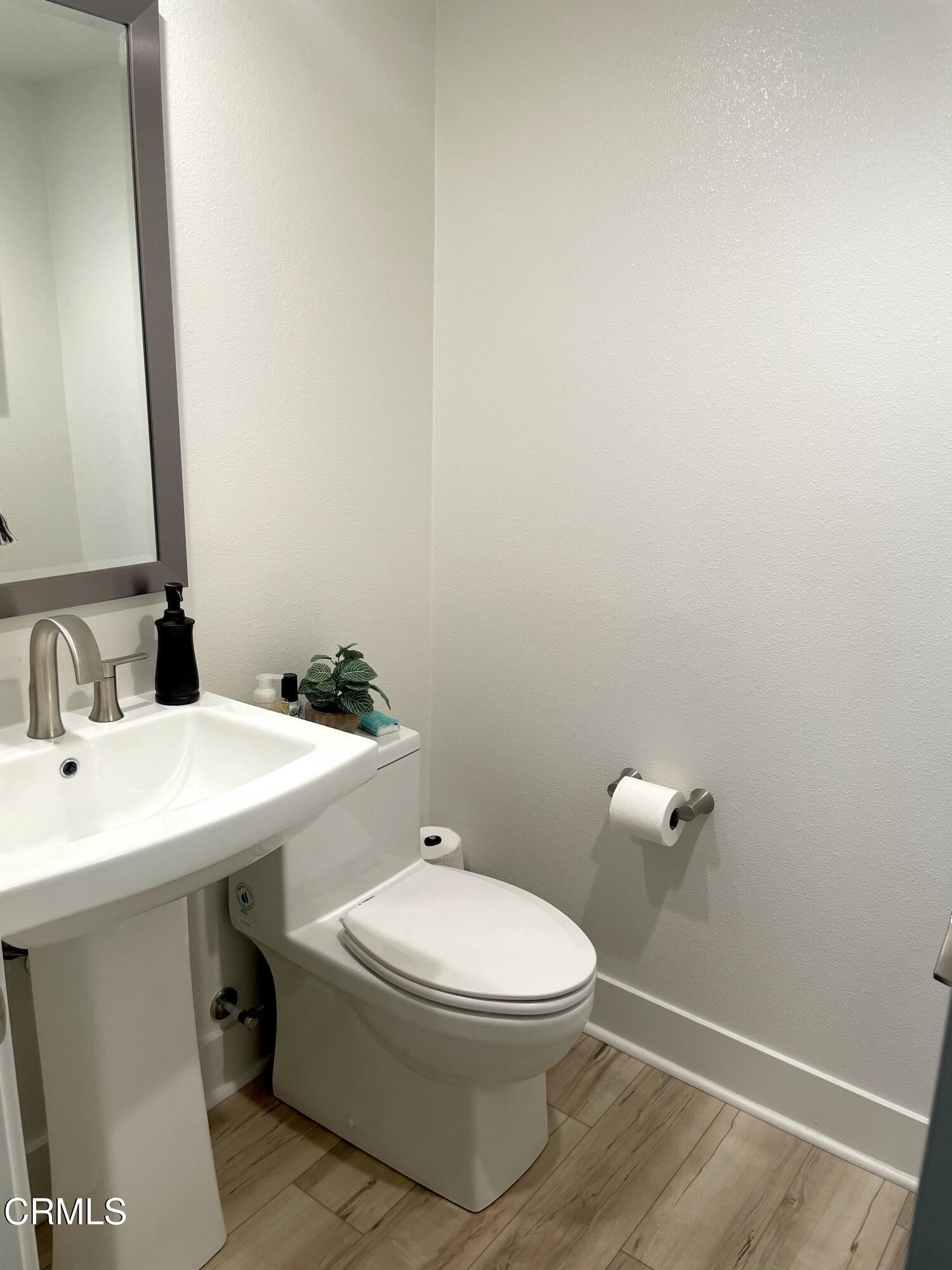1066 Canal Street Oxnard, CA 93035 - Photo 29 of 34 a bathroom with a toilet a sink and mirror