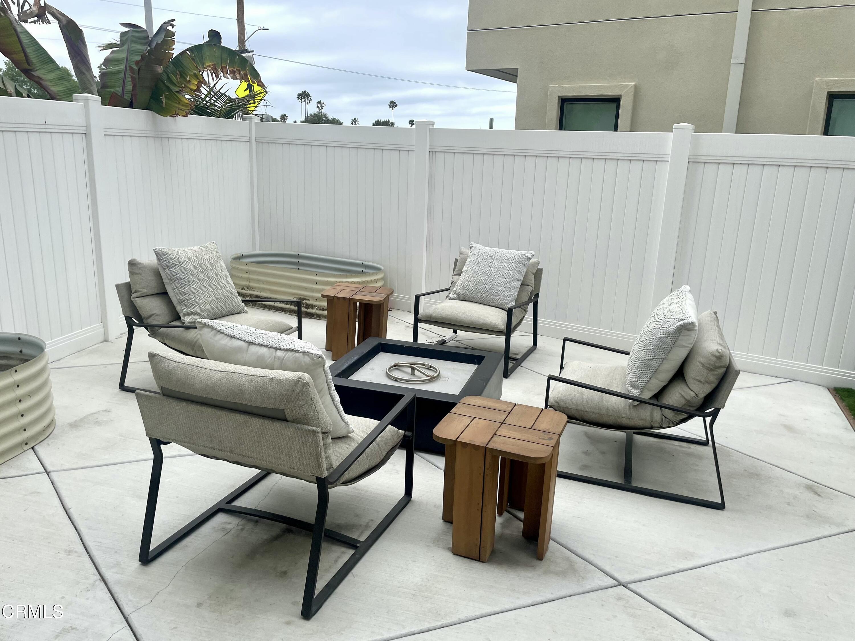 1066 Canal Street Oxnard, CA 93035 - Photo 30 of 34 a couple of blue chairs sitting in patio of a house