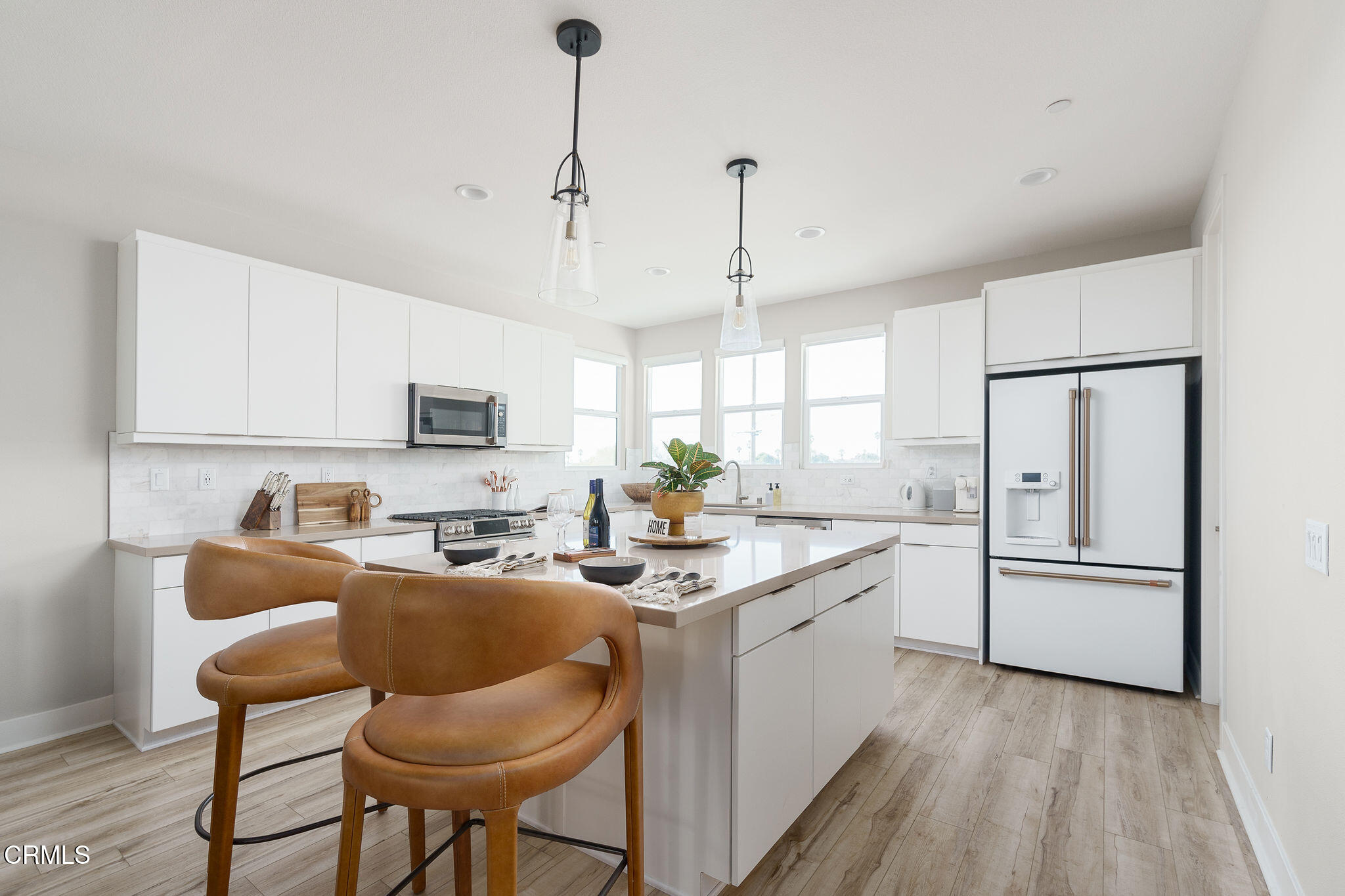 1066 Canal Street Oxnard, CA 93035 - Photo 8 of 34 a kitchen with stainless steel appliances granite countertop refrigerator sink and cabinets