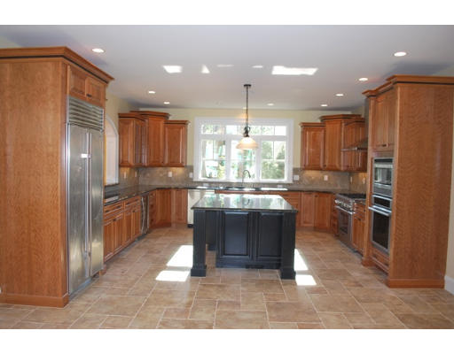 3 Martingale Road, Unit LOT #1 Lexington, MA 02421 - Photo 5 of 10 a kitchen with kitchen island granite countertop wooden floors appliances and cabinets
