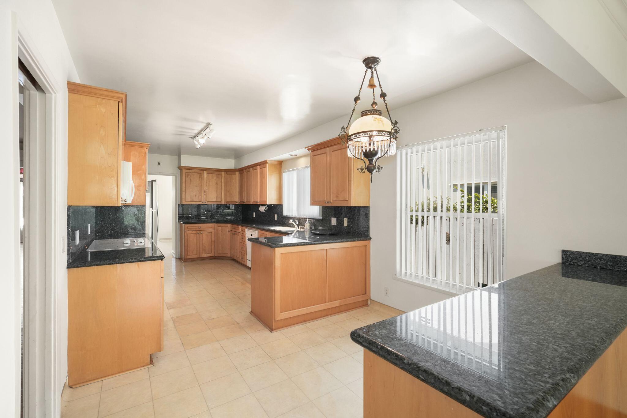 108 West Kenneth Road Glendale, CA 91202 - Photo 34 of 47 a open kitchen with stainless steel appliances granite countertop a stove and refrigerator