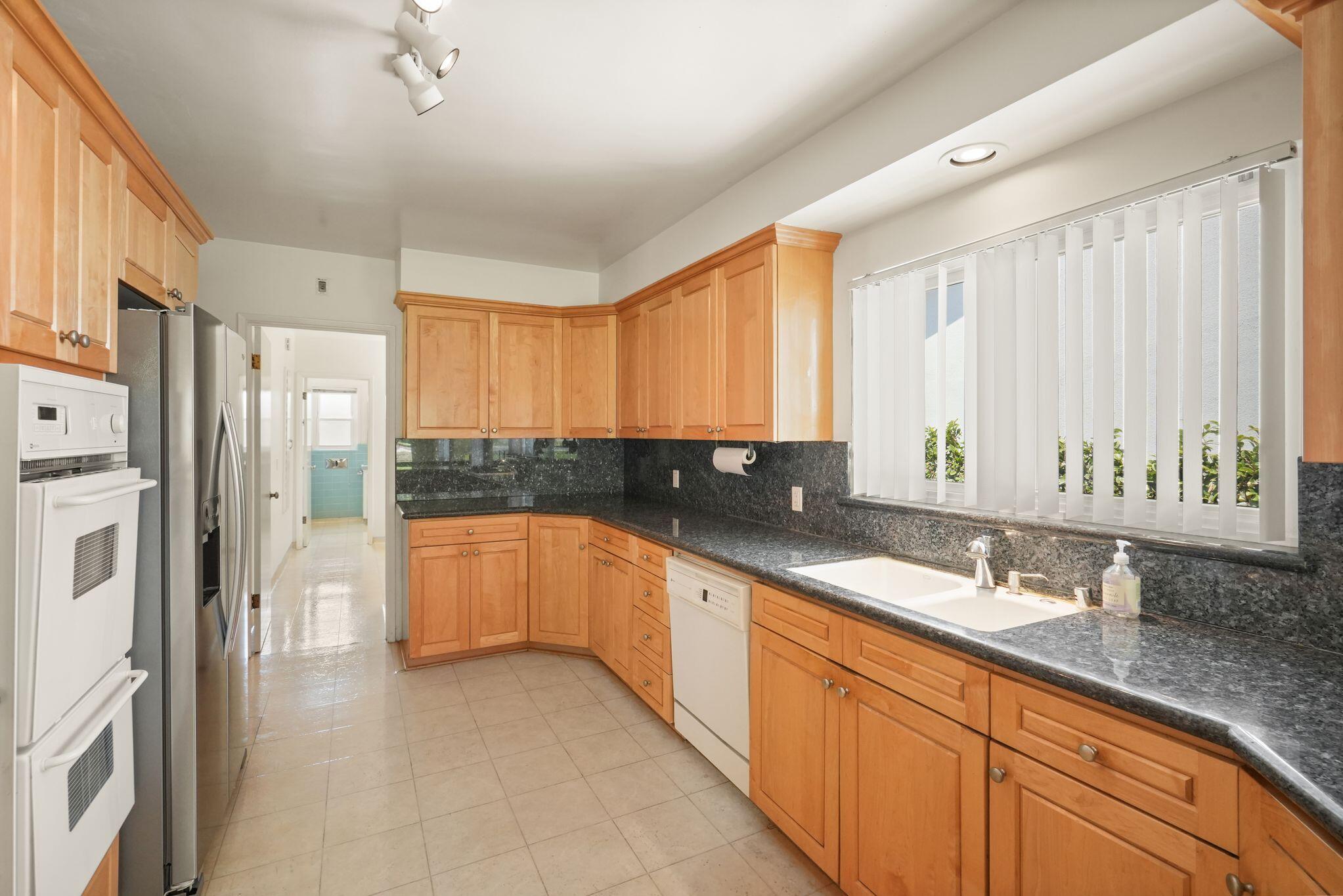 108 West Kenneth Road Glendale, CA 91202 - Photo 36 of 47 a large kitchen with stainless steel appliances granite countertop a refrigerator and a sink